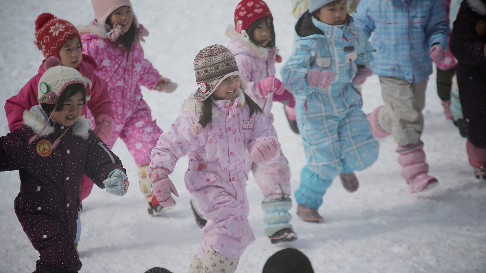 Children running together at a kindergarten sports day