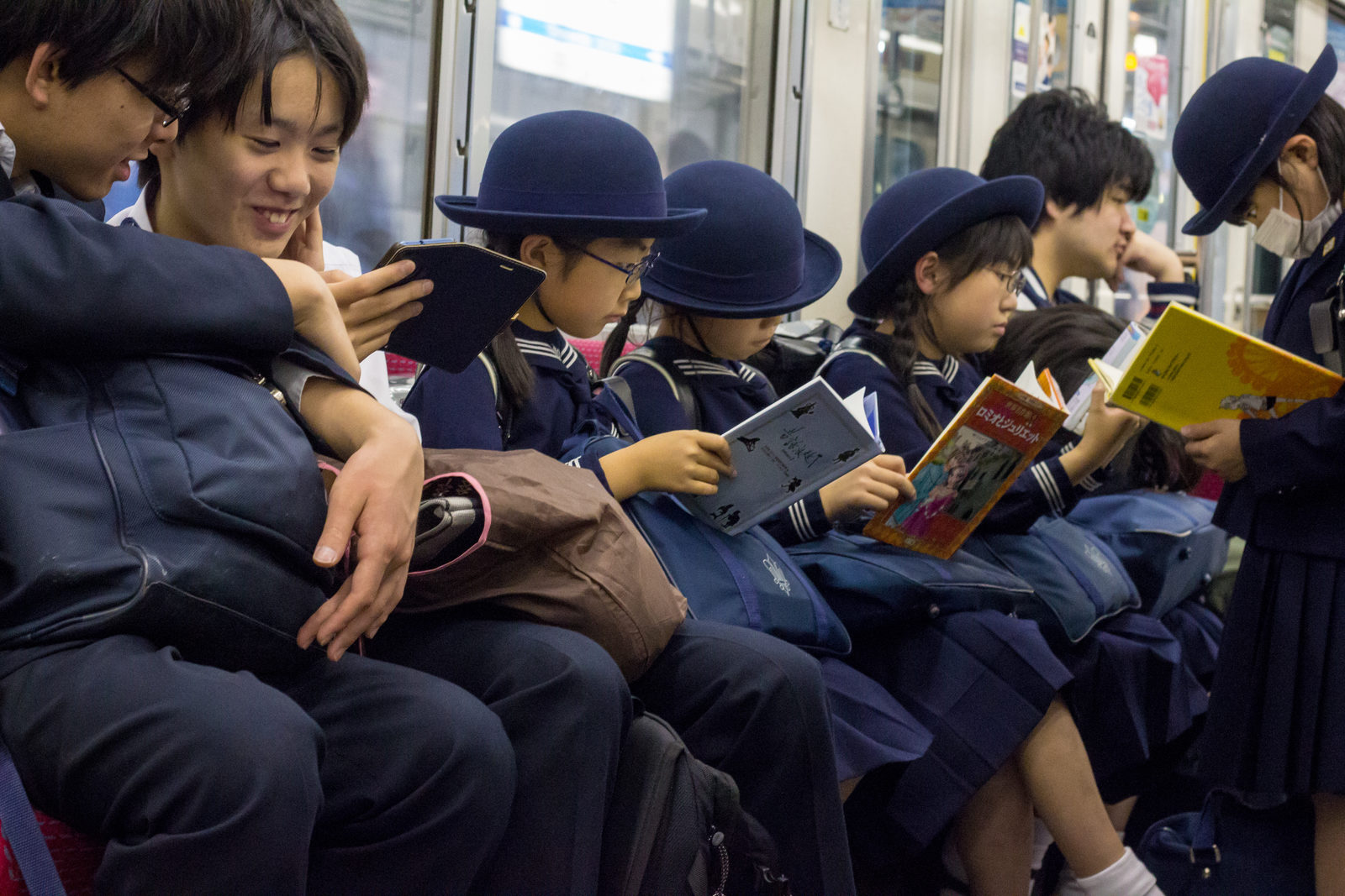 Schoolchildren reading together on the way home