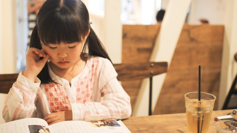 A child absorbed in her own book