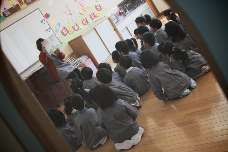 A teacher with her class gathered round her