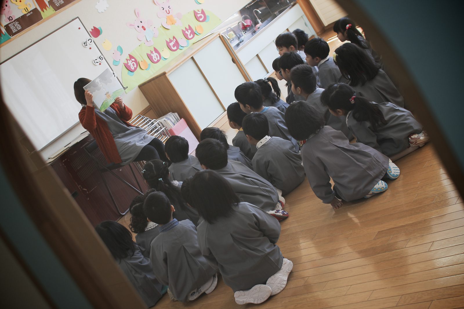 A teacher with her class gathered round her