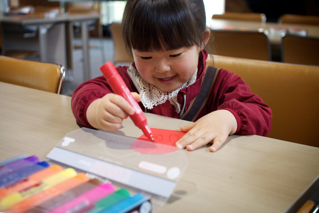 A child drawing with coloured markers